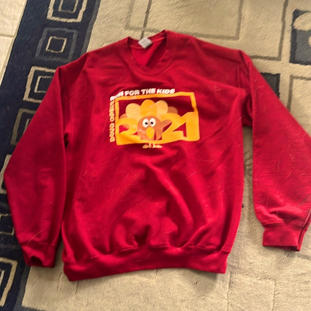 This sweatshirt is red and it’s from a race it’s size M.